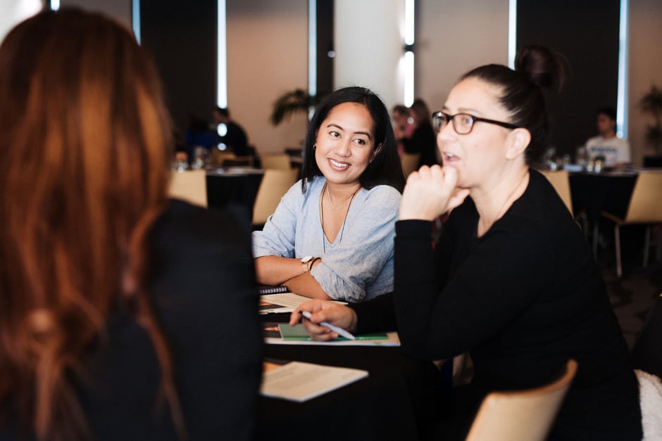 Women laughing at facebook workshop.