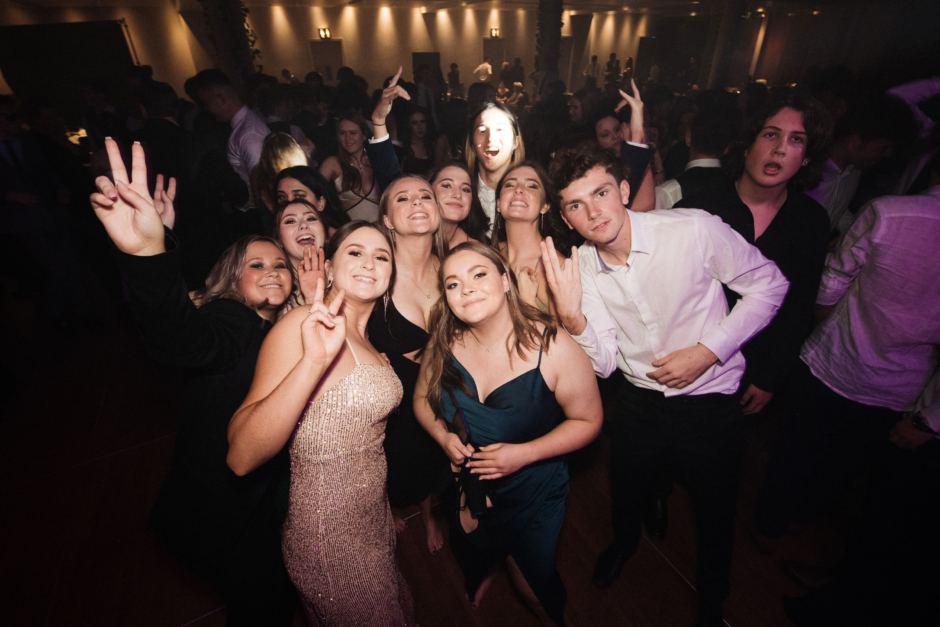 Big group photo on dance floor at Hilton Auckland school ball.